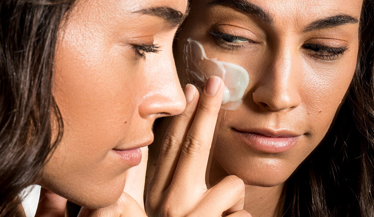 Woman using cream against dry skin